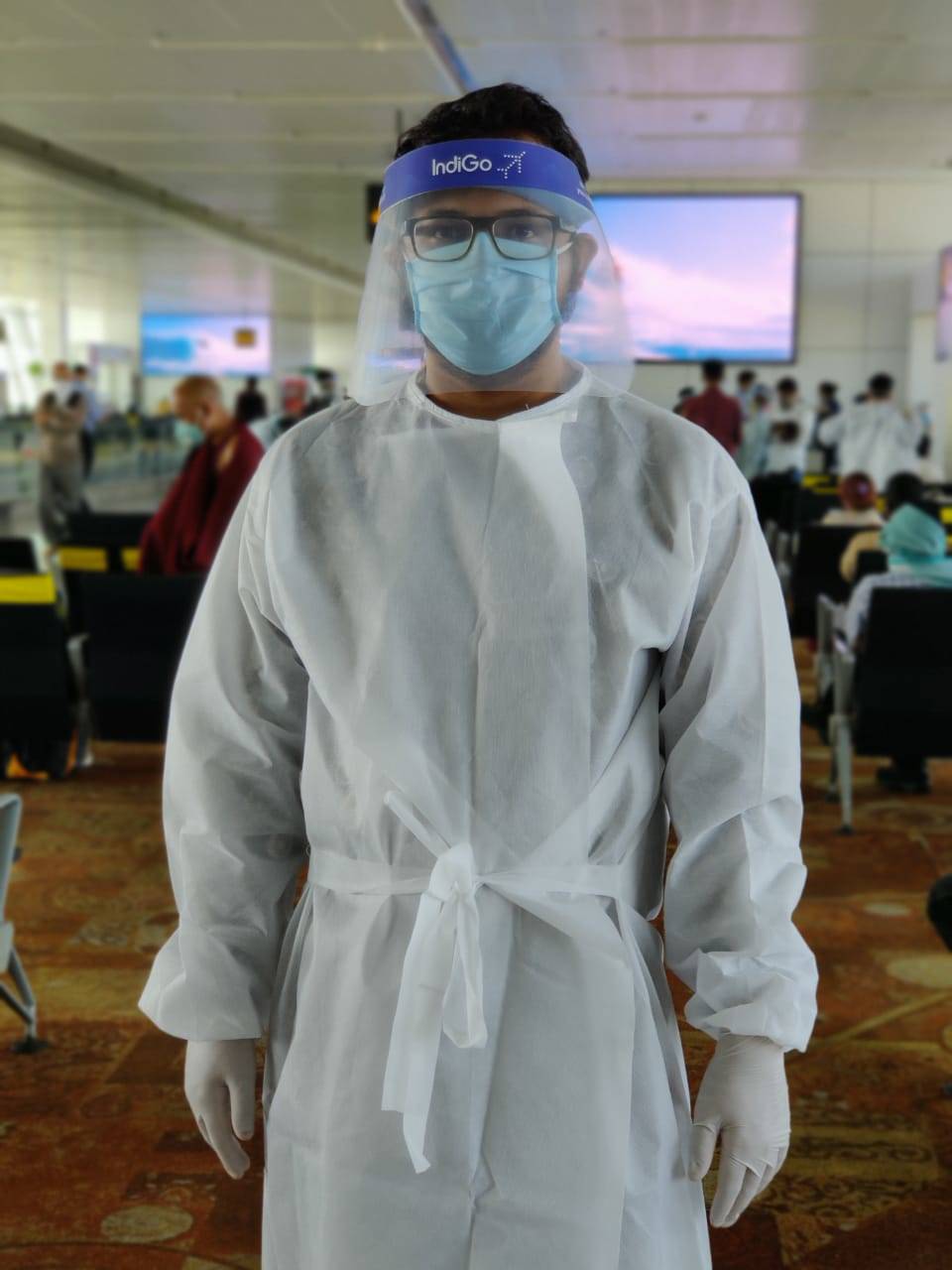 A middle seat passenger wearing the PPE kit