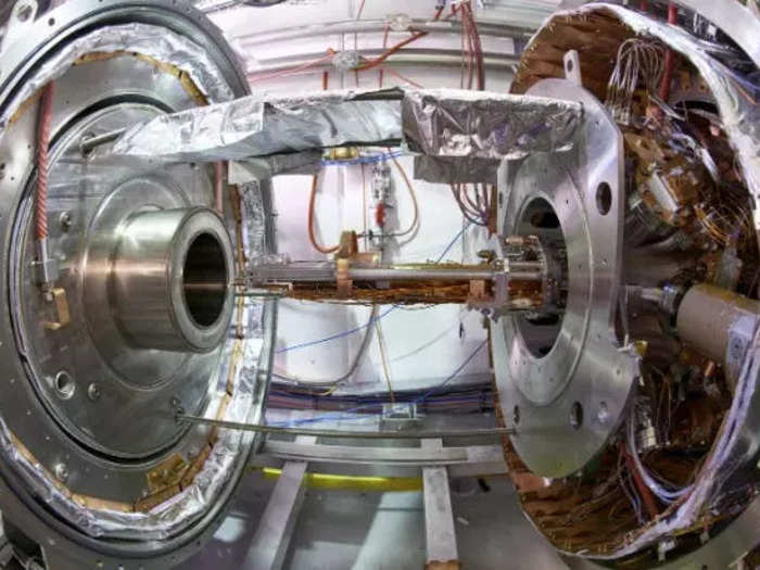 After ELANA slows them down, antiprotons make their way to different experiments in the antimatter factory. The AEgIS experiment, for example, uses the antihydrogen production trap, shown here, with strong magnets on each side that capture antimatter. Physicists then observe gravity