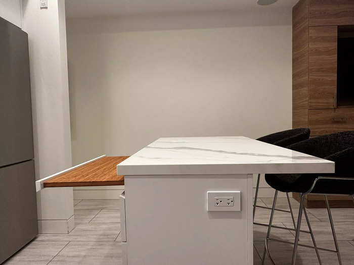 The design team thoughtfully included convenient features for small spaces, including a pull-out cutting board disguised as a drawer in the kitchen island.