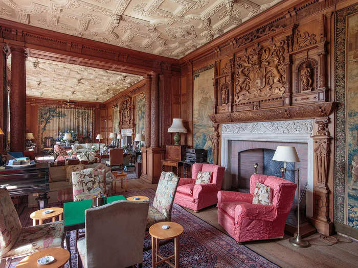 There is "intricate craftsmanship" throughout the drawing room. Above the fireplace are the crests of the families associated with the ancient castle.