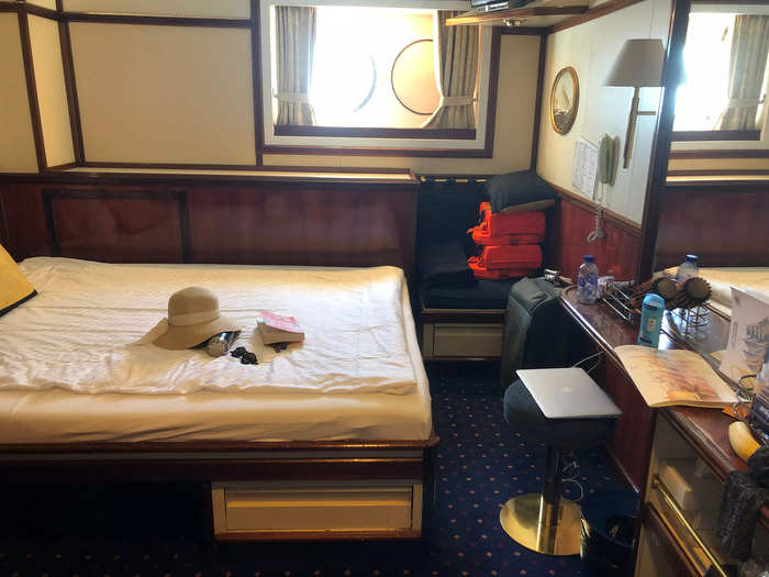 I made my way to my room, a 118-square feet Commodore Deck cabin with a double bed, dressing table, closet, bathroom, and porthole windows.