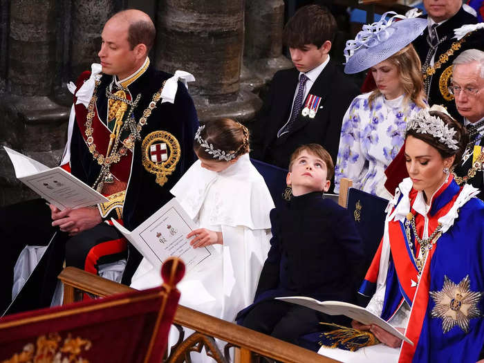 While his family read from their ceremony programs, Louis took a look at the ceiling of Westminster Abbey.