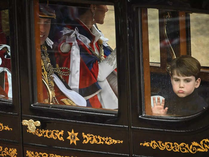 Leaving the coronation ceremony with his family, Louis pulled a glum face.