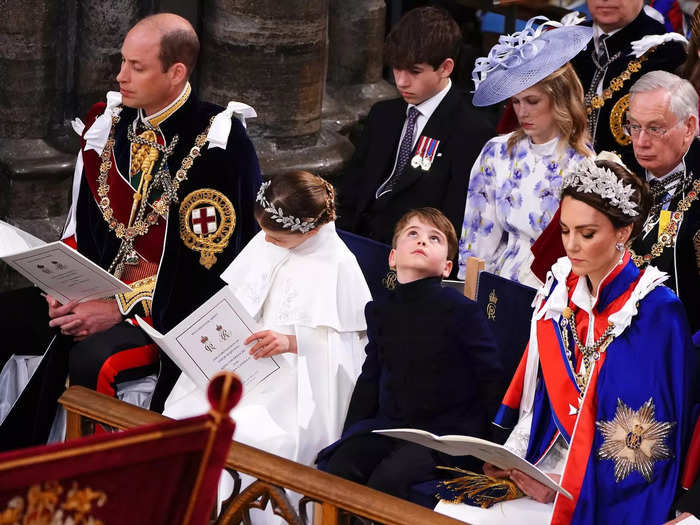 While his family read from their ceremony programs, Louis took a look at the ceiling of Westminster Abbey.