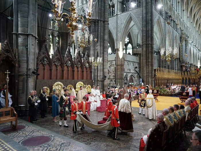 Inside Westminster Abbey, George and the other pages had an important responsibility: carrying the train of King Charles