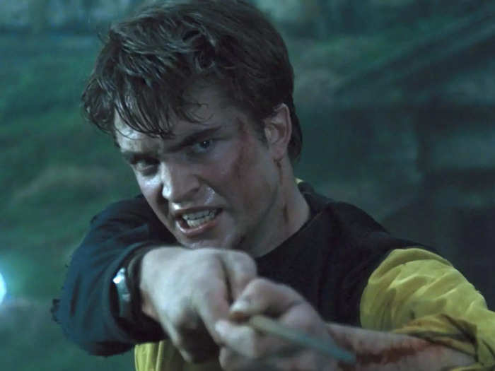 Throughout the film, Robert Pattinson holds his wand like a gun.