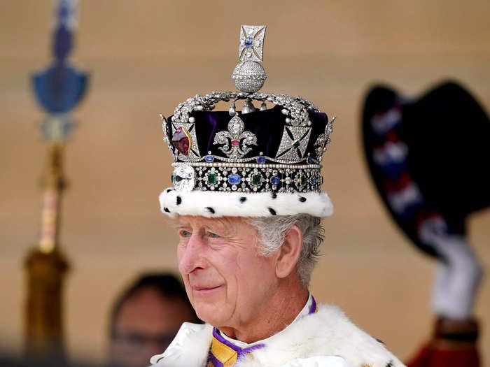 At Buckingham Palace, King Charles offered a soft smile while wearing the St Edward