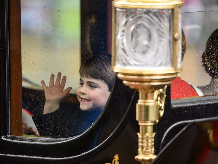 Prince Louis smiled as he was seated in the carriage by his siblings, Prince George and Princess Charlotte, while it drove past the crowds.