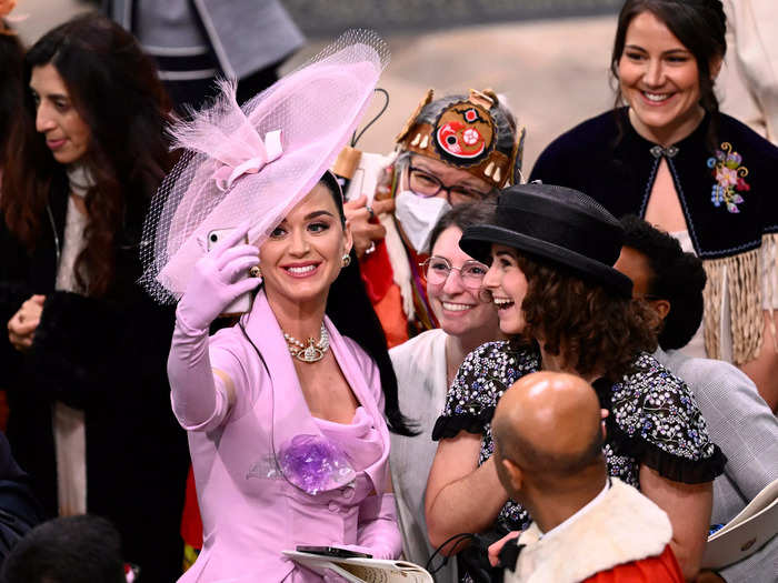 Celebrity guests, including Katy Perry, appeared unaware that she was being photographed while taking selfies.