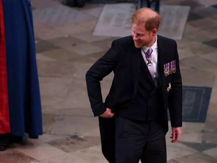 Prince Harry wore a simple morning suit rather than a military uniform, but pinned military medals to his jacket.