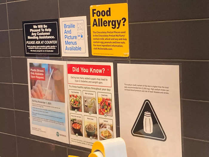 A colorful collage of warnings next to the cashier