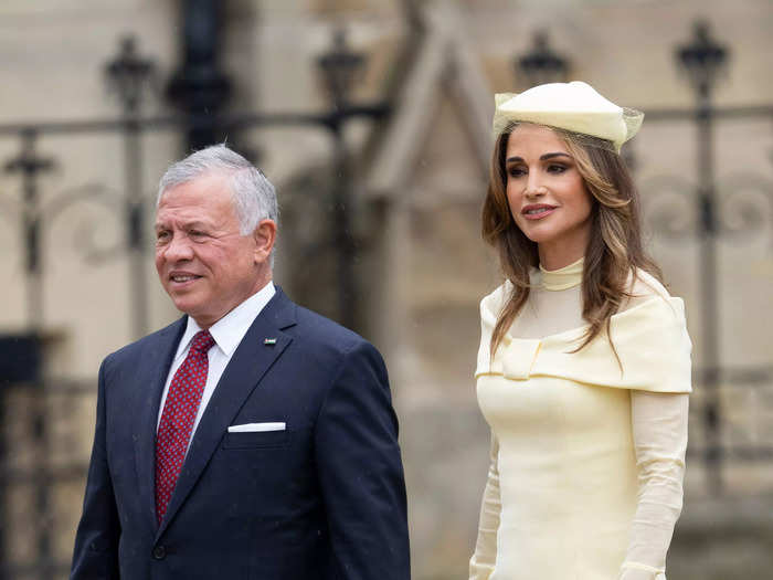 King Abdullah II of Jordan wore a simple navy suit with a red tie while his wife, Queen Rania, wore a pale yellow couture midi dress.