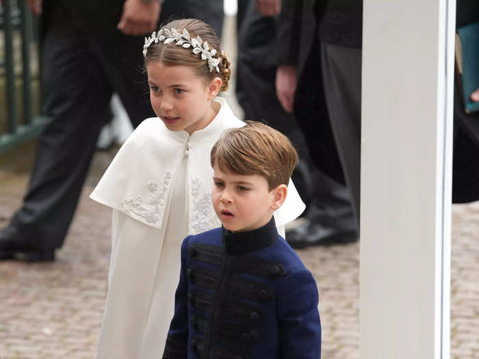 Similar to her mother, Princess Charlotte wore an ivory white caped dress and flower crown, while Prince Louis wore a navy tunic and pants.