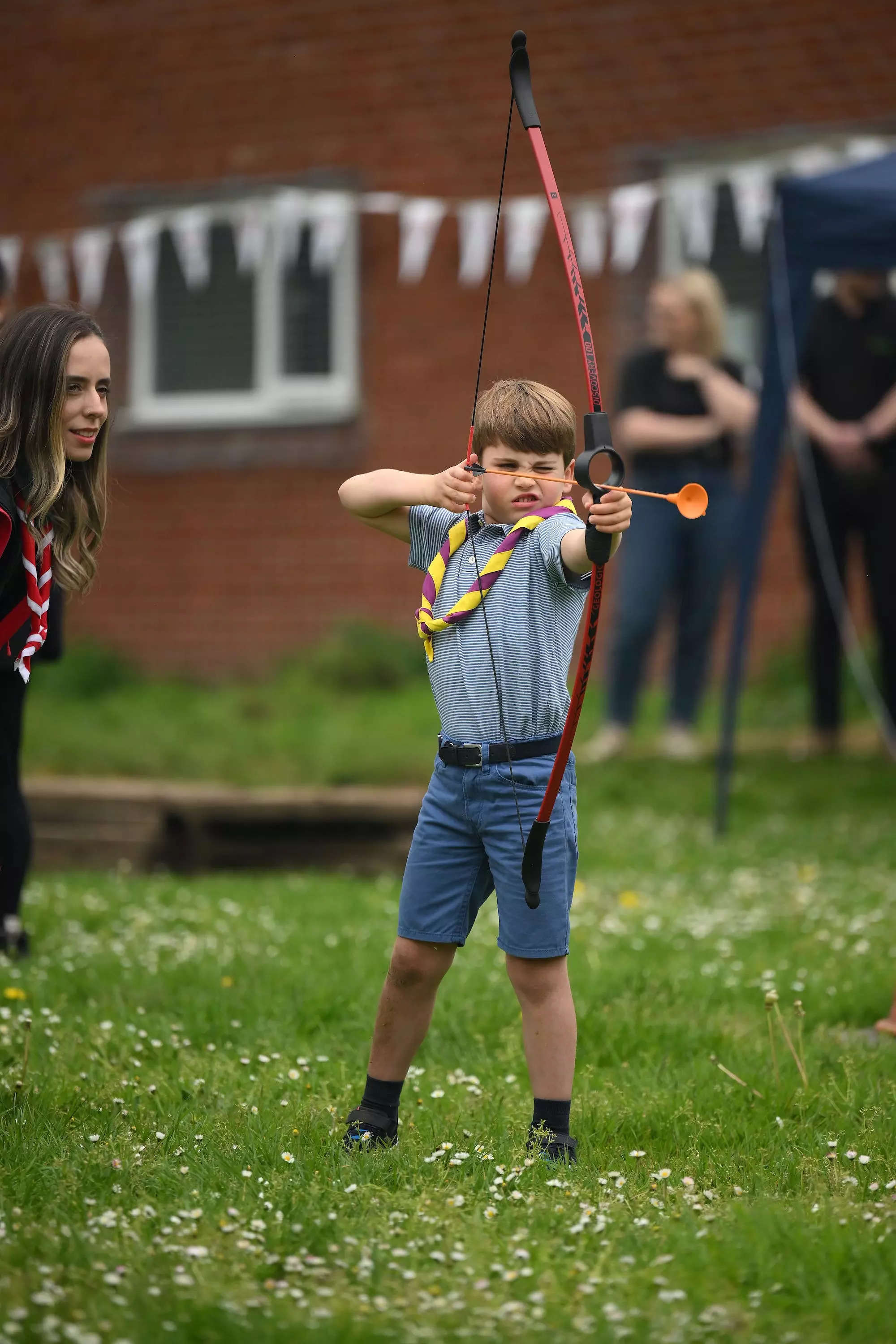 Prince Louis shoots an arrow at the Big Help Out.