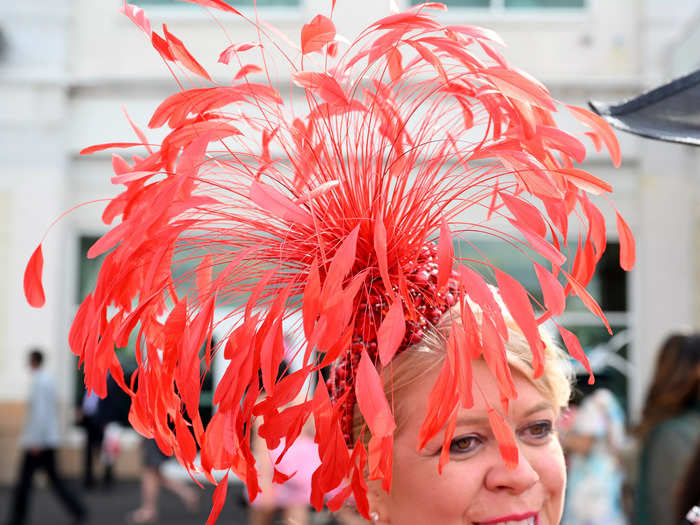 This attendee wore an eccentric red hat with feathers springing out of its center.