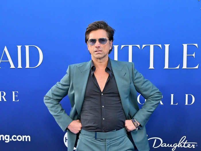 John Stamos had fun posing for his red carpet photos.