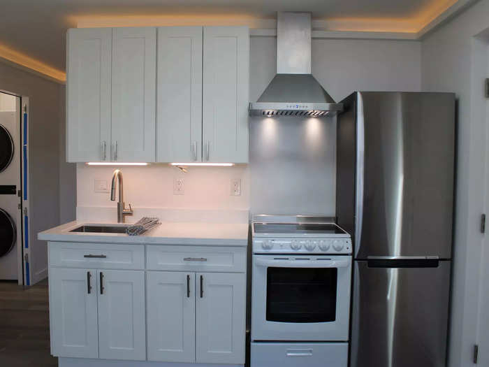 Swanky lighting installed above the cabinetry made the unit feel warm and homey. Here is the kitchen, situated to the right when you walk in the front door.