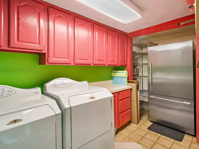 The colorful walls and cabinets even extend to the laundry room.