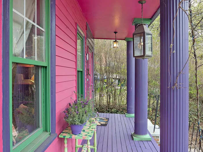 The whimsical details of the home start on the front porch. Purple and green columns give you a sneak peek of the cacophony to come.