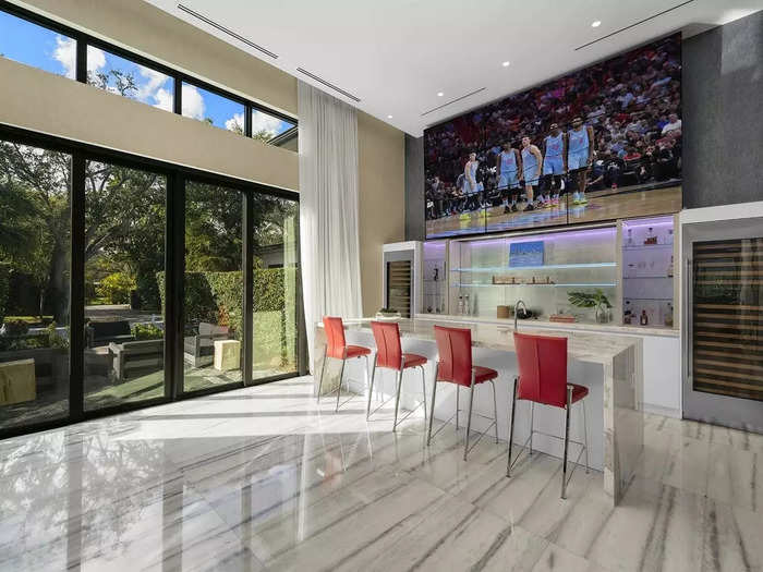 The house has its own sports bar with TVs over the bar flanked by a pair of wine fridges.