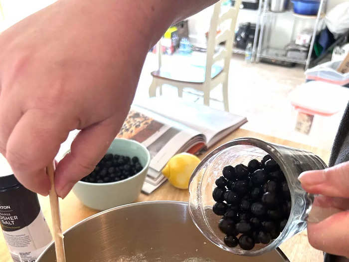 Once my batter was ready, I began adding the blueberries.