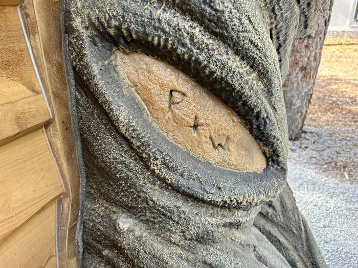 A tree trunk next to the door had "P+W" carved into it — a nod to Peter and Wendy from the fairy tale.