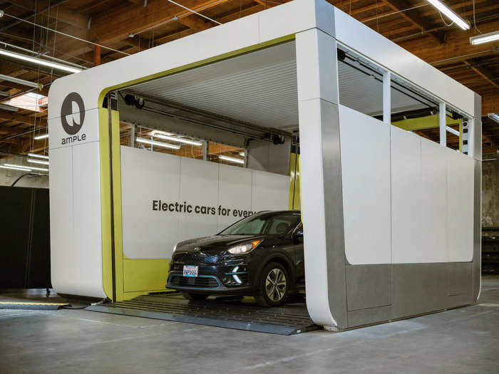 Drivers pull up and park their EV inside the Ample station.