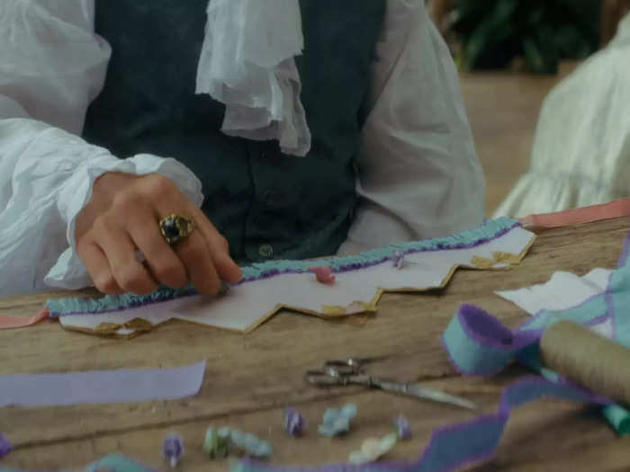 In episode three, Violet first brings up making hats with her father.