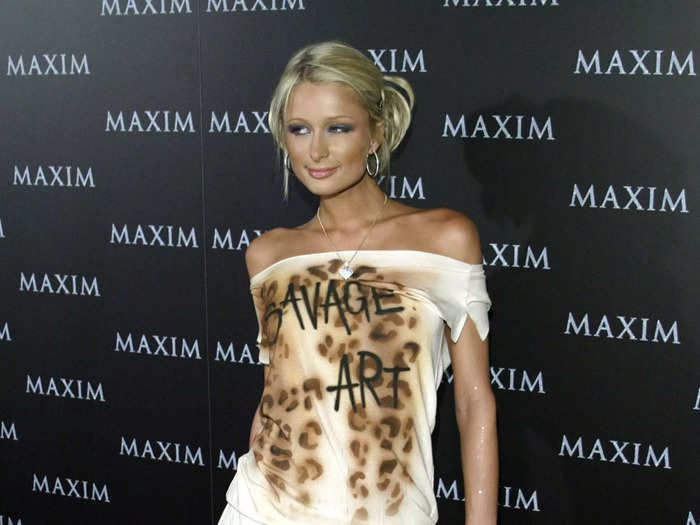 In 2002, Paris Hilton paired an off-the-shoulder shirt that read "Savage Art" with a torn mini skirt.