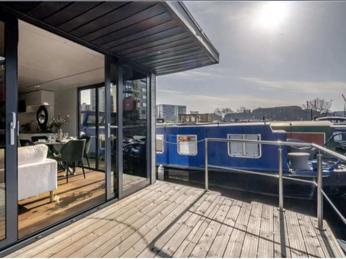 The living room opens out onto a decking area, perfect for relaxing on warm days and evenings