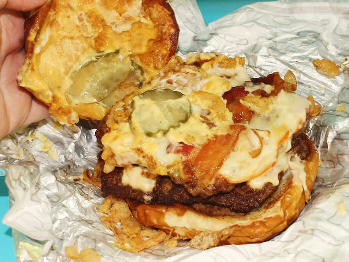 The burger, which comes on a pretzel bun, came with a whopping three quarter-pound burger patties, Muenster cheese, strips of Applewood-smoked bacon, honey mustard, beer cheese sauce, fried onions, and pickles.