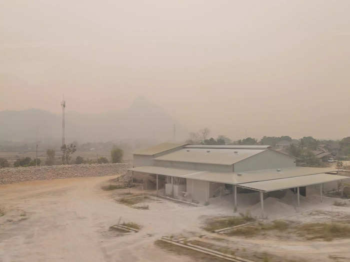After around an hour, the train arrived in Vang Vieng. But what I saw was reminiscent of a post-apocalyptic film, with pale-white ash covering everything, from the buildings to the trees.