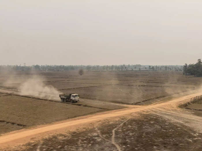 As the train traveled deeper in the Laotian countryside, acres of crop fields could be seen, against the backdrop of smog covering the jungle and sky.