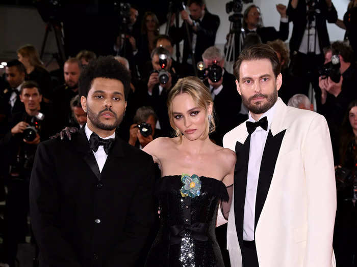 Director Sam Levinson, Lily-Rose Depp, and Abel "The Weeknd" Tesfaye posed together for photographers on the red carpet.