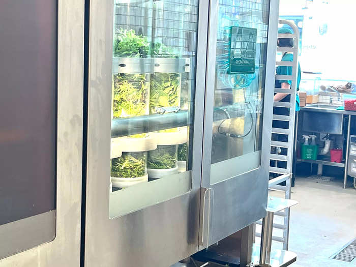 The Infinite Kitchen machine uses tubes to dispense and mix the greens. Humans have to periodically refill the tubes with ingredients.