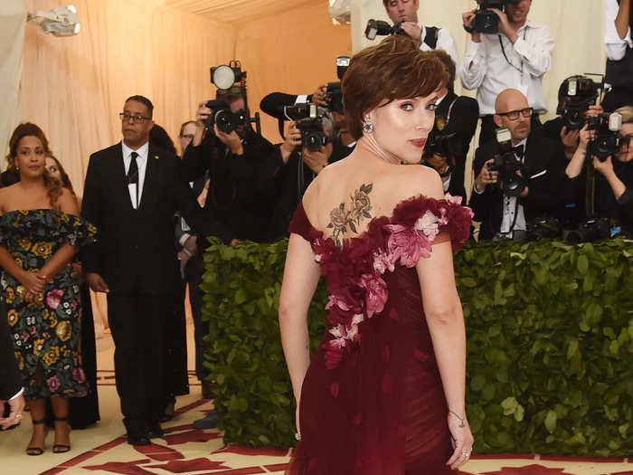 At the 2018 Met Gala, Johansson wore a dress designed with flowers that matched her back tattoo.