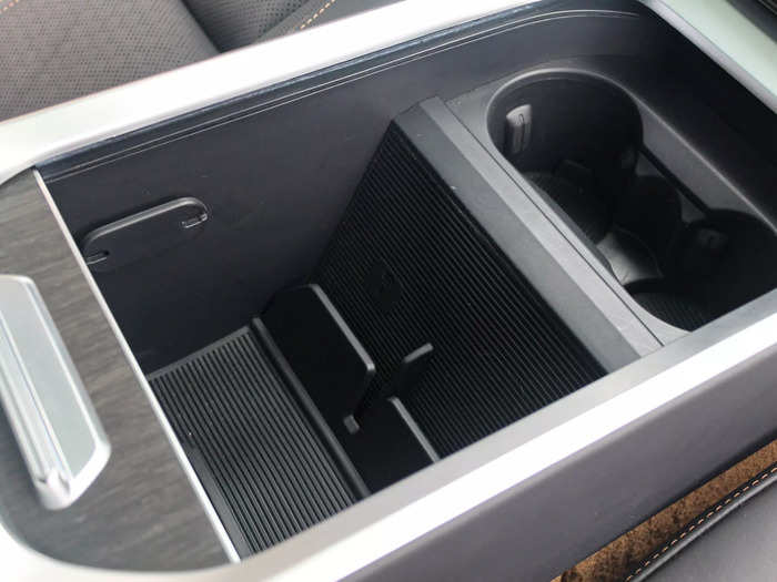 Between the front seats, there