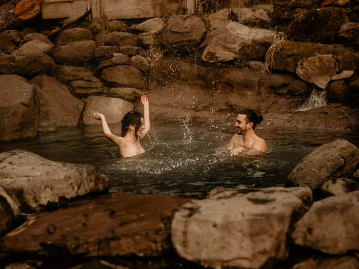 A snapshot of pure joy shows a couple in a hot spring.