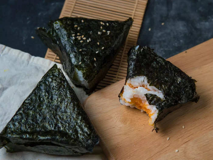 The restaurant describes onigiri as rice balls wrapped in seaweed and stuffed with fillings like salted fish, pickled vegetables, and dried shrimp.