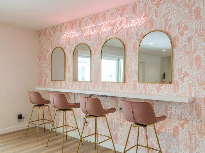 The beauty bar was decorated with pink, cactus wallpaper and a neon sign that said "Hotter than the desert," so it was functional and added to the festive feel of the home.