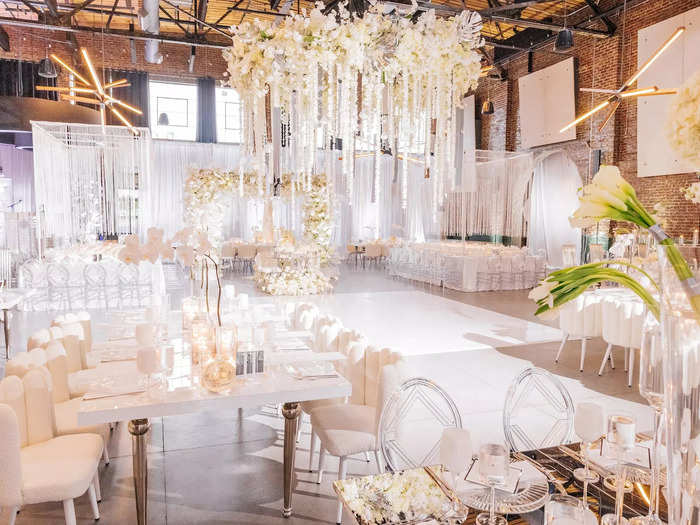 The luxury wedding had an all-white theme and featured everything from a nine-tier cake to a flower chandelier.