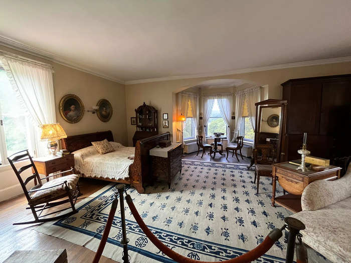 The spacious primary tower bedroom, the largest bedroom in the home, featured gorgeous views of the Hudson and portraits of the Young children over the bed.