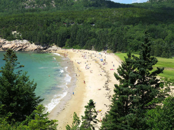 Sand Beach at Acadia National Park in Maine is surrounded by breathtaking greenery.