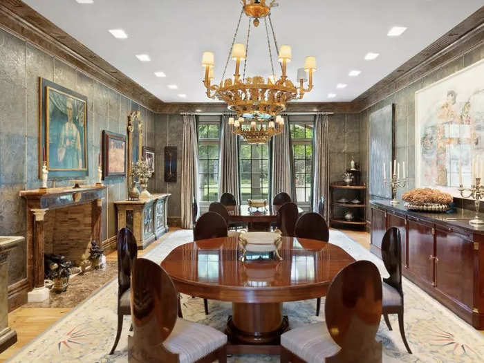 This is another sitting room, featuring stone walls and a grand chandelier.