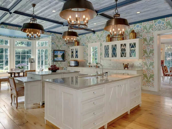 The unique ceiling in the kitchen is made of reclaimed barn wood, marble countertops, and a separate nook with bay windows.