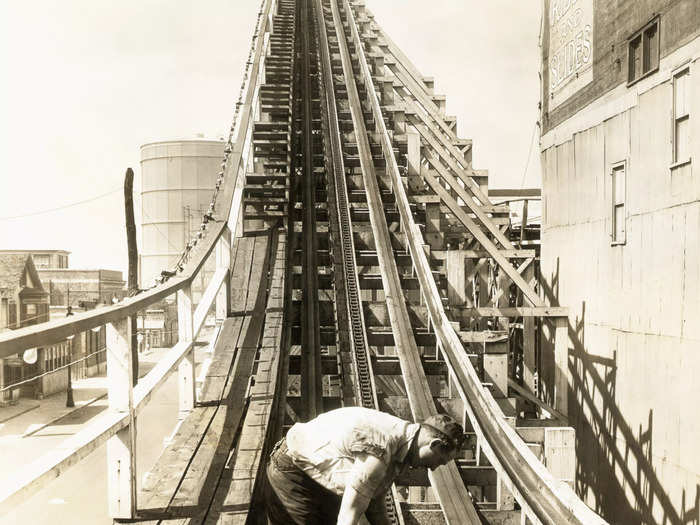 A man greases the chain on the Cyclone, the amusement park