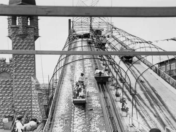 In 1903, four onlookers watched riders on the Shoot the Chutes water ride.