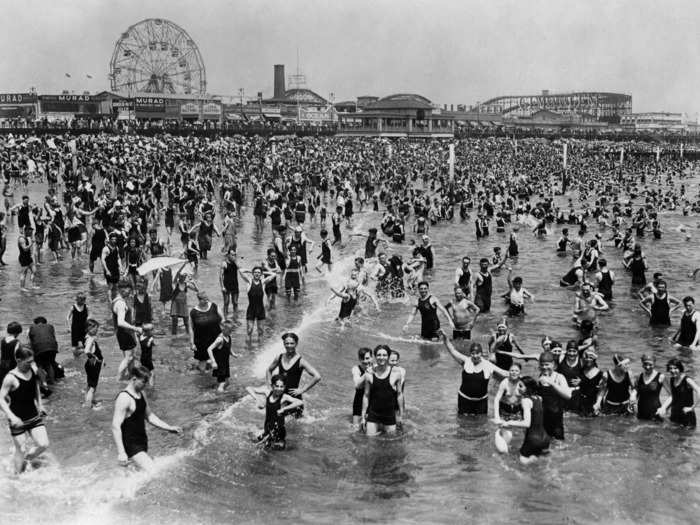 Crowds swarmed the waterfront on hot summer days, while other visitors enjoyed the rides at the amusement park behind them.