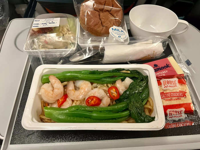 For meals, travelers will not get the same business class service that comes with a hot towel and tablecloth. But, the food is good, with options including beef, chicken, and prawns.