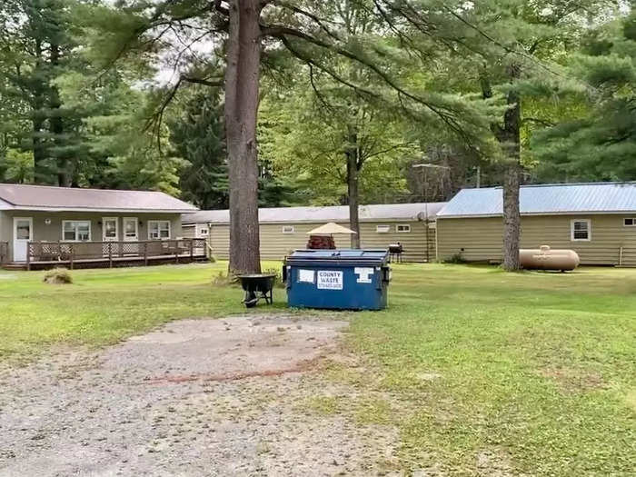 The outdoor space and a dumpster on the property of an old motel